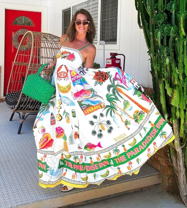 reviewer modeling a maxi dress featuring tree, fish, and other artistic designs