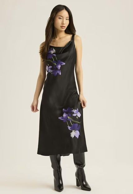 A model elegantly dressed in a black floral dress