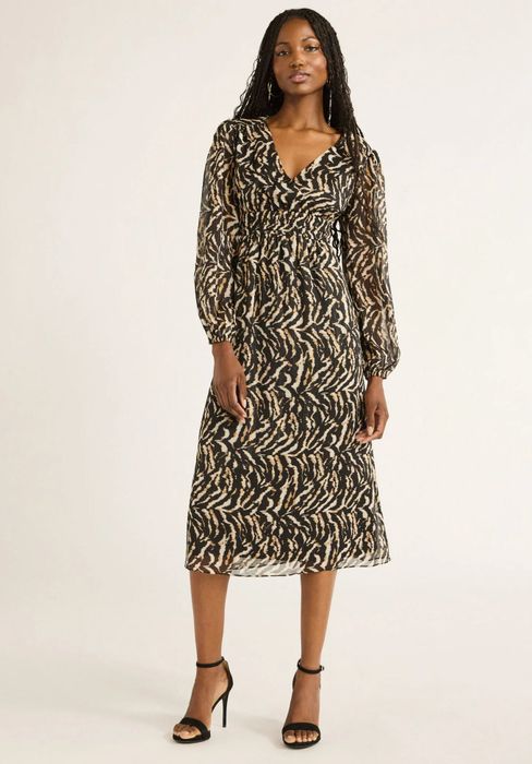 Model showcasing the animal print dress.