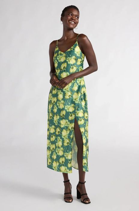 A model showcasing a beautiful green floral dress