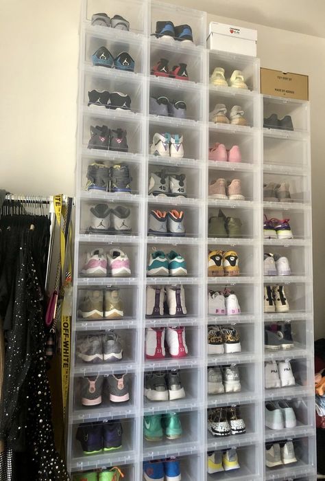 A Mytour editor's clear shoeboxes, stacked four across and 13 high, filled with sneakers in her bedroom