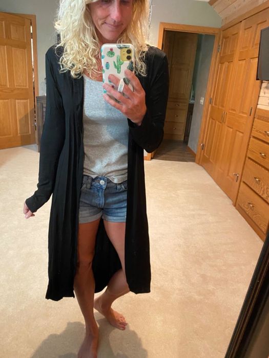 Reviewer showcasing the black duster cardigan