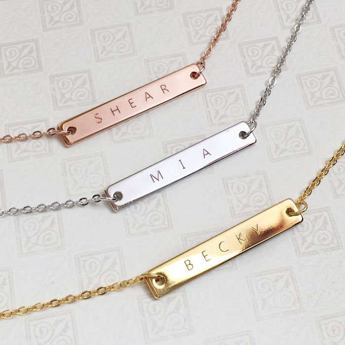 Three bar necklaces in rose gold, silver, and gold, each engraved with names