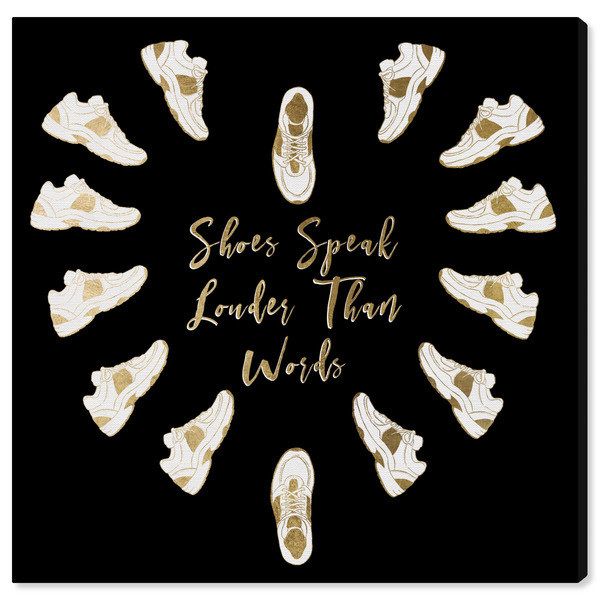 A black canvas print featuring white and gold sneakers arranged in a heart shape with the phrase "shoes speak louder than words" in the center