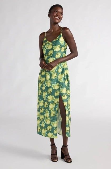 Model wearing the dress featuring a green floral pattern