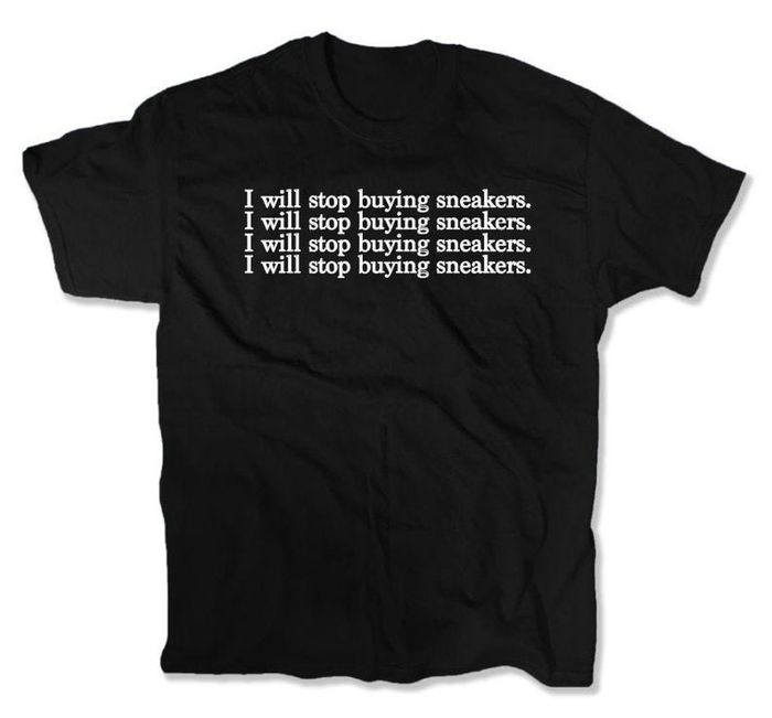 A black T-shirt with white text repeating "I will stop buying sneakers" four times in a row