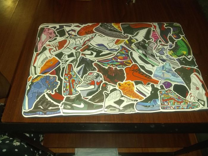 A reviewer’s laptop adorned with sneaker stickers