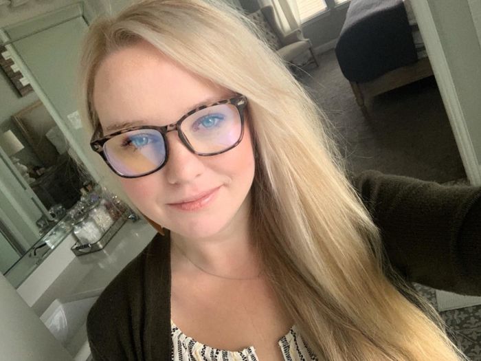Reviewer wearing leopard-print blue light blocking glasses