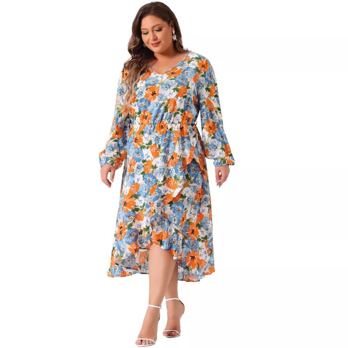 A model wearing a long-sleeve floral dress and white heels, posing in a studio environment.