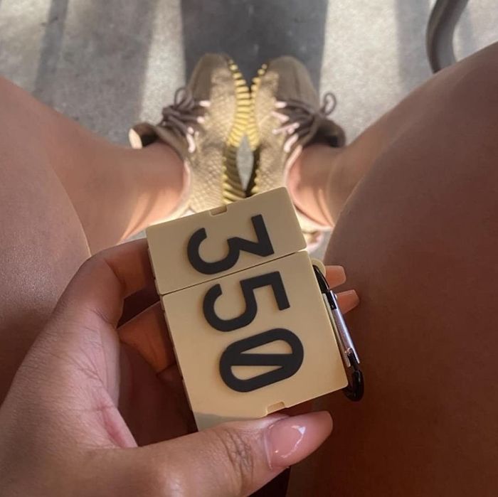 A reviewer holding the closed case designed to resemble a shoebox