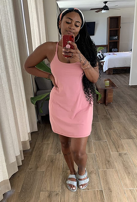 a reviewer wearing the sleeveless pink dress