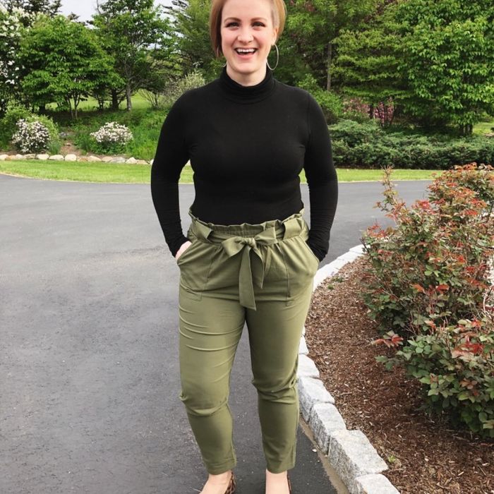 Reviewer wears the same style pants in green, paired with a black turtleneck and leopard-print flats