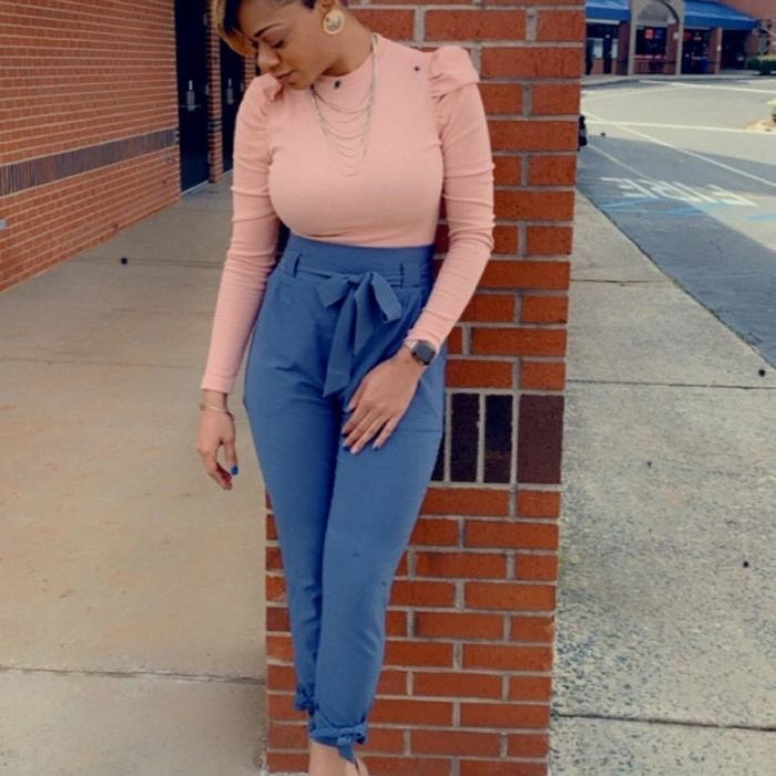 Reviewer is seen in blue paperbag waist pants with a ruffled pink blouse