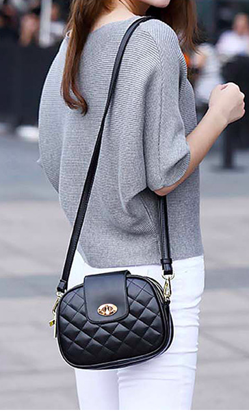 A model is seen carrying the quilted turn-lock bag