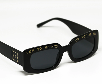 black sunglasses inscribed with ‘Talk to Me Nice or Not at All’