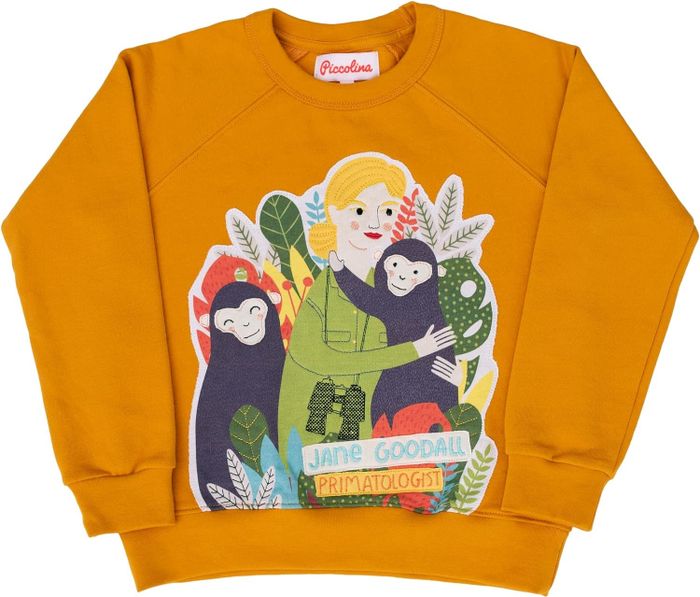 A yellow sweatshirt adorned with Jane Goodall and monkeys embroidered on it