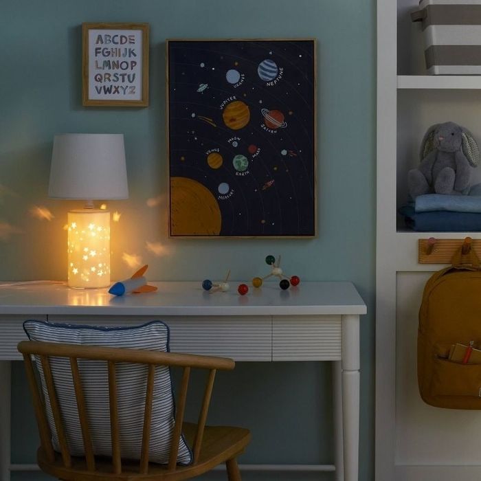 a lamp in nightlight mode casting starry patterns on a wall