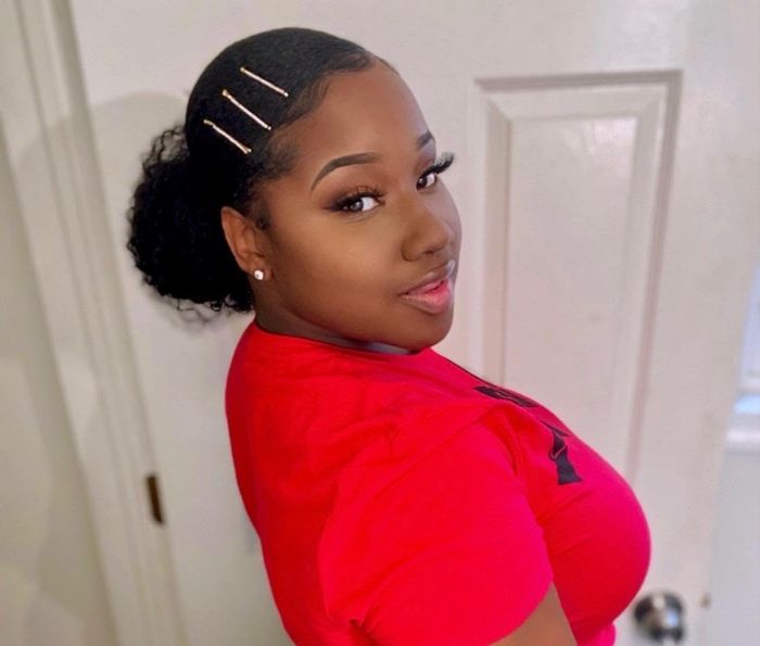 Reviewer with hair styled in a slicked-back low bun and perfectly laid edges