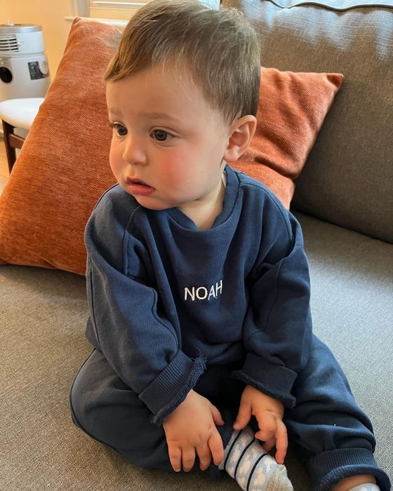 A Mytour editor’s toddler wearing a navy blue sweat set with his name embroidered on the shirt