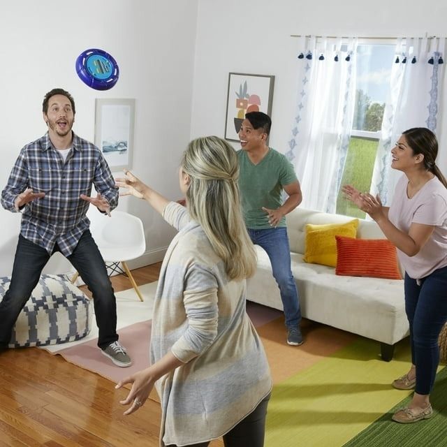 Four people enjoying a game together indoors.