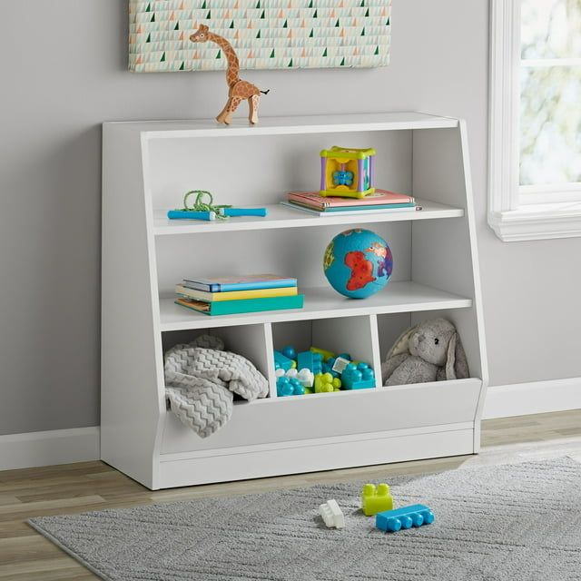 A white bookshelf with bins for storing toys and books