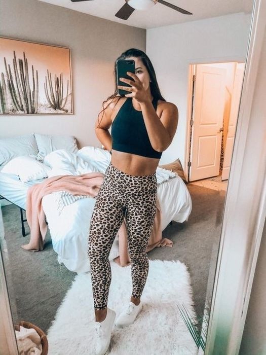 A reviewer wearing leopard print leggings