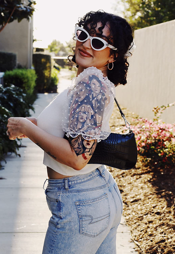 reviewer styling the black bag with an outfit