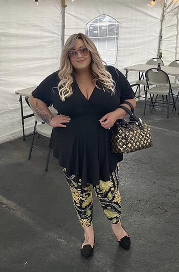 reviewer wearing the black wrap top