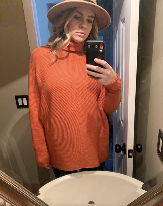A reviewer wearing the turtleneck sweater