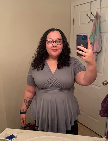 reviewer wearing the grey wrap tunic