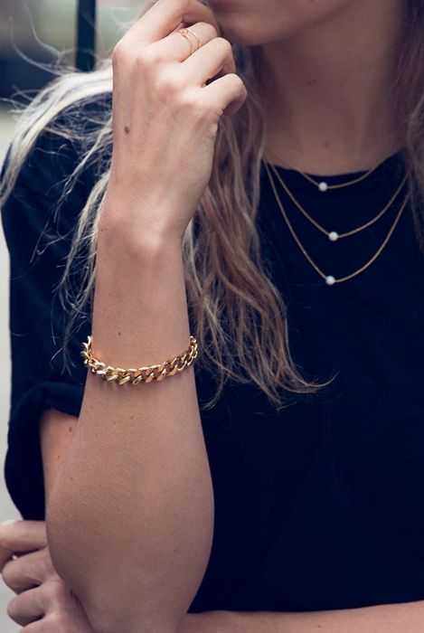 a model showcasing the elegant gold chain bracelet