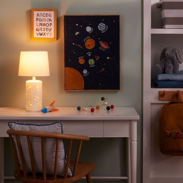 a lamp featuring star-shaped cutouts placed on a desk