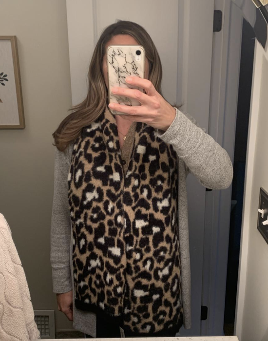 A reviewer wearing the leopard scarf