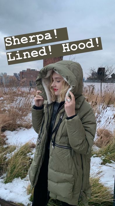 Mytour Senior Editor showcasing the olive green coat with text