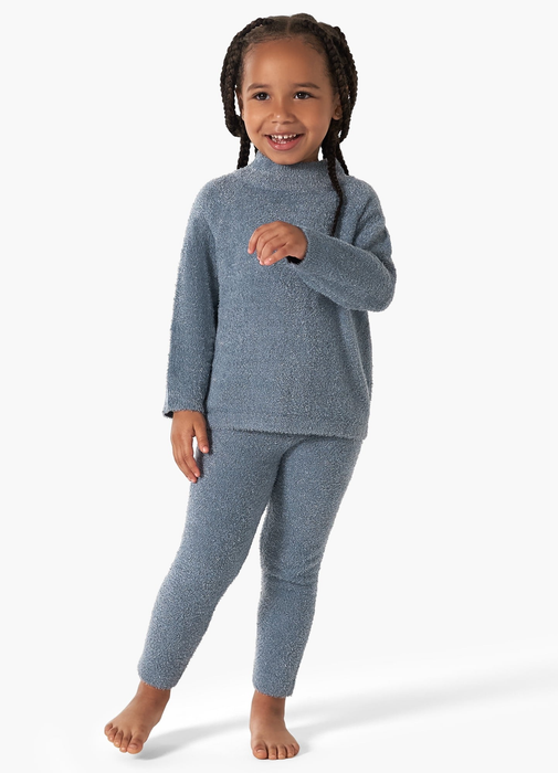 A toddler wearing a cozy blue plush sweatshirt and matching pants