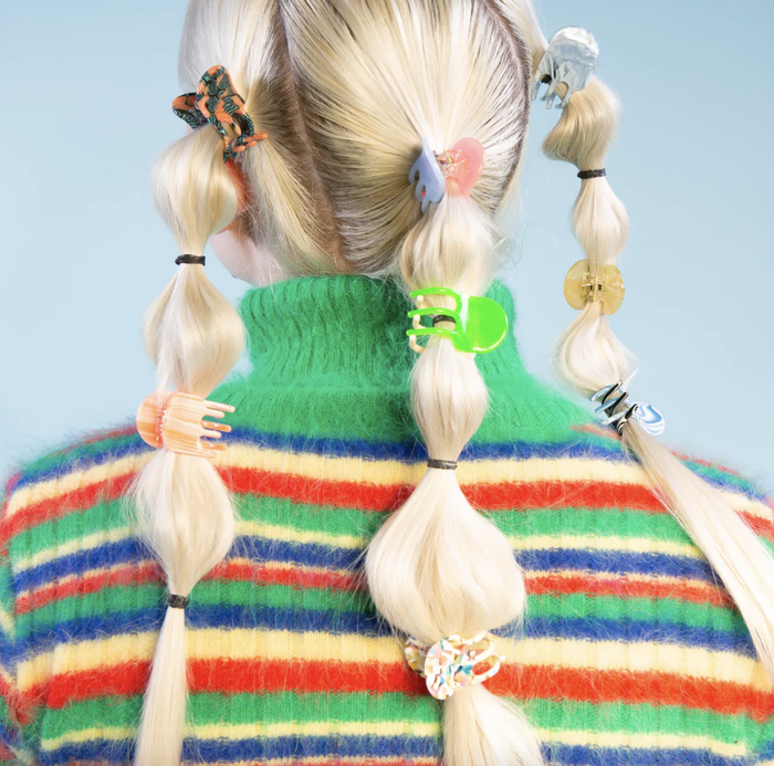 Back view of a model wearing multiple mini clips in their hair