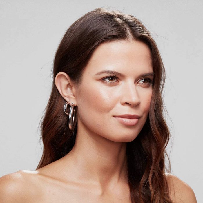 A model wearing the hoop earrings