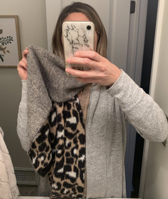 A reviewer showing the gray underside of the scarf
