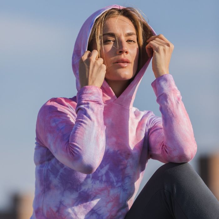 A model wearing the purple tie-dye sweater