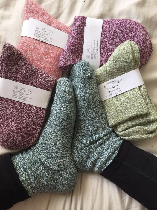A reviewer wearing the green socks