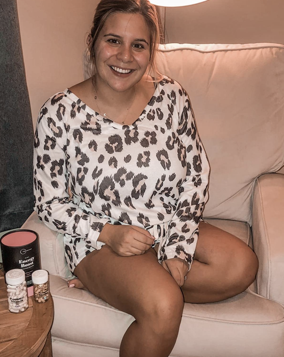 A reviewer showcasing a leopard print sweater and shorts set