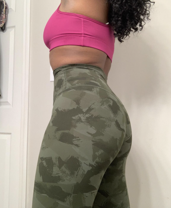 A reviewer wearing olive green army leggings