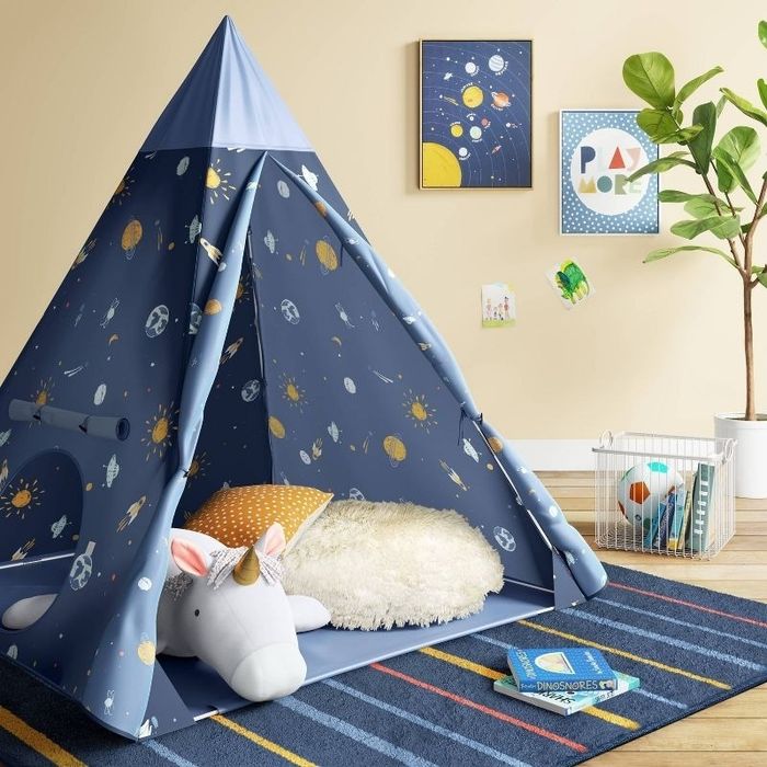 a space-themed play tent set up in a room