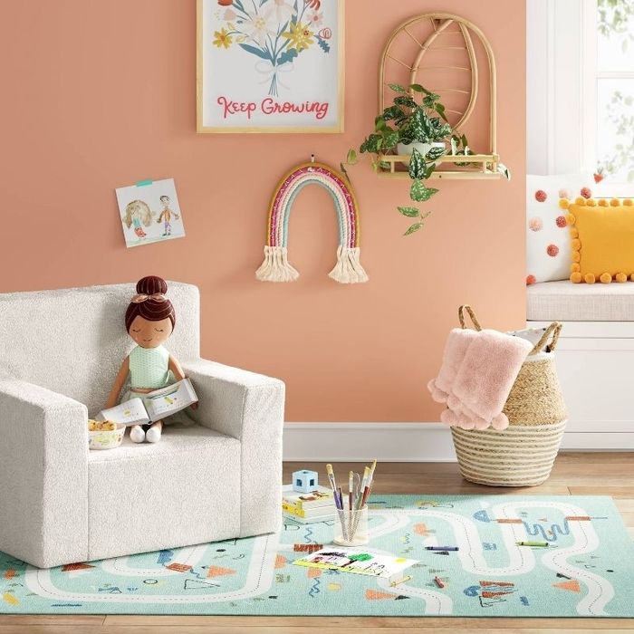 a square rug with a road print in a child's room