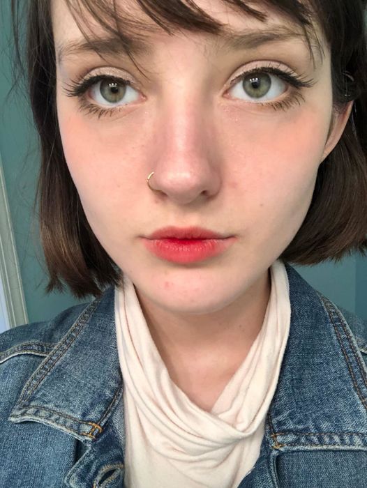 Reviewer showcasing the red lip tint