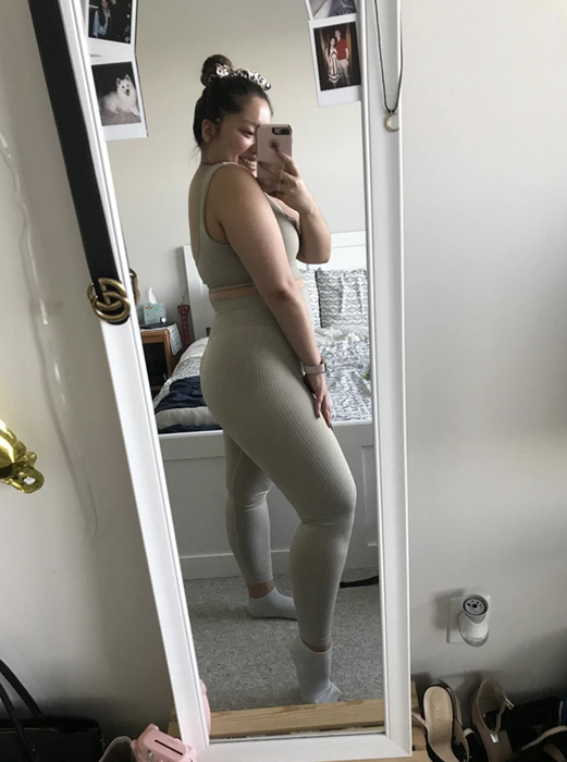 Reviewer in a matching gray crop top and leggings