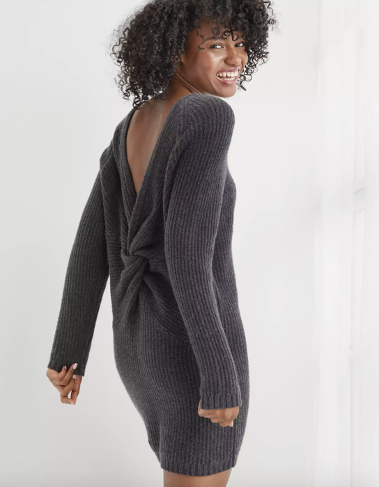 A model wearing the gray mini twist-back dress