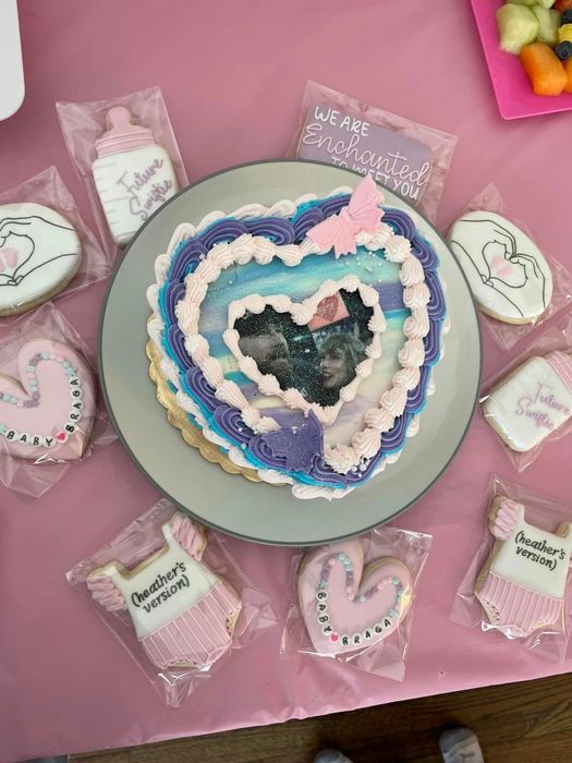 Custom cake and cookies on a table, some featuring 
