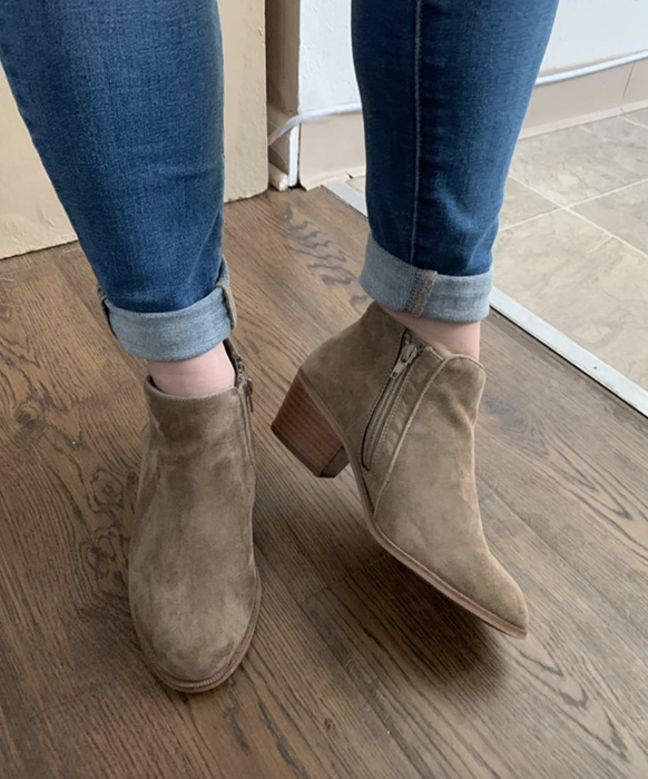 A reviewer wearing the taupe booties