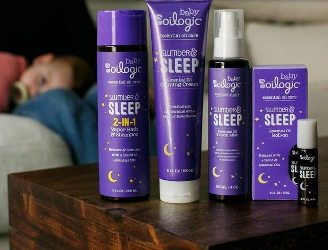 Four bottles of essential oils resting on a nightstand